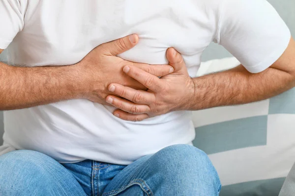 Mature man suffering from heart attack at home, closeup — Stock Photo, Image