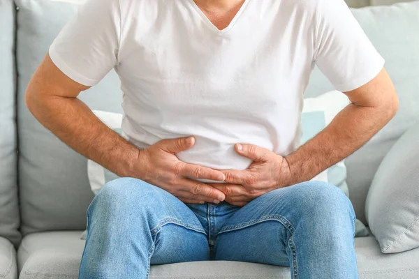 Mature man suffering from abdominal pain at home — Stock Photo, Image