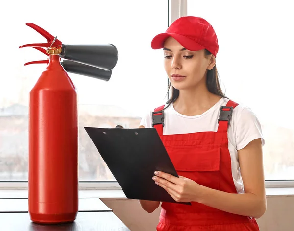 Especialista em segurança contra incêndio inspecionando extintor — Fotografia de Stock