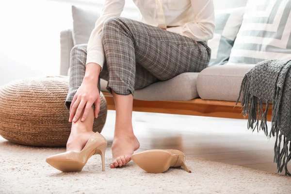 Young woman feeling ache because of wearing high heels at home — Stock Photo, Image
