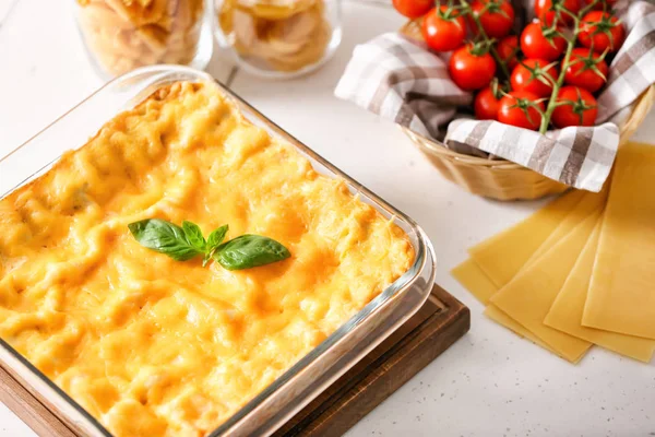 Baking dish with prepared lasagna on white table — Stock Photo, Image