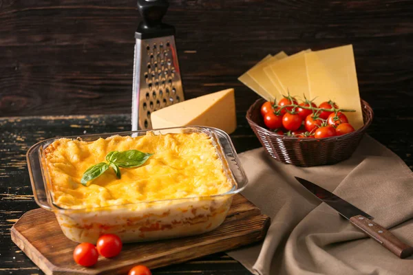 Baking dish with prepared lasagna on table — Stock Photo, Image