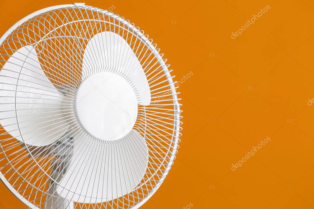 Electric fan on color background