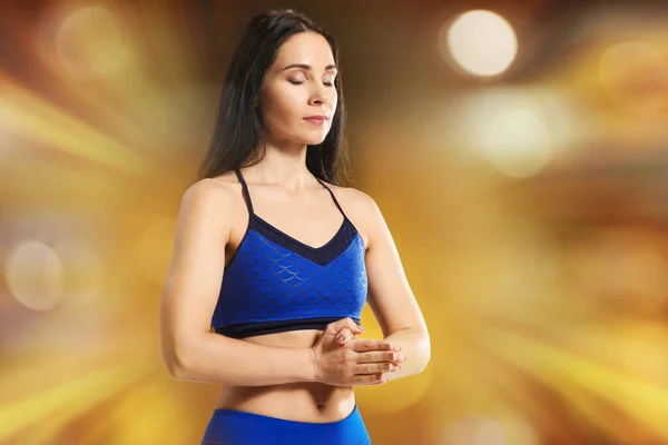 Meditating woman on color background