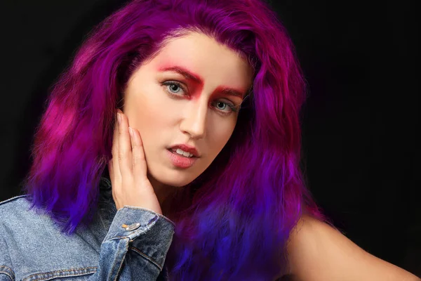 Young woman with creative hair and eyebrows on dark background — Stock Photo, Image