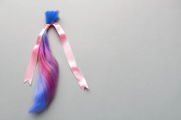 Colorful dyed hair strand and ribbon on grey background — 스톡 사진