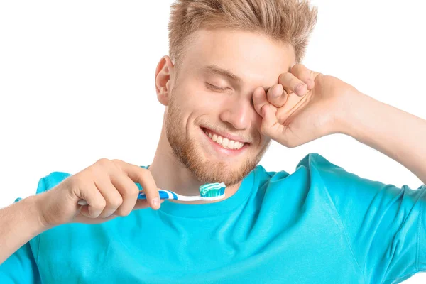 Young man with toothbrush on white background — Stock Photo, Image