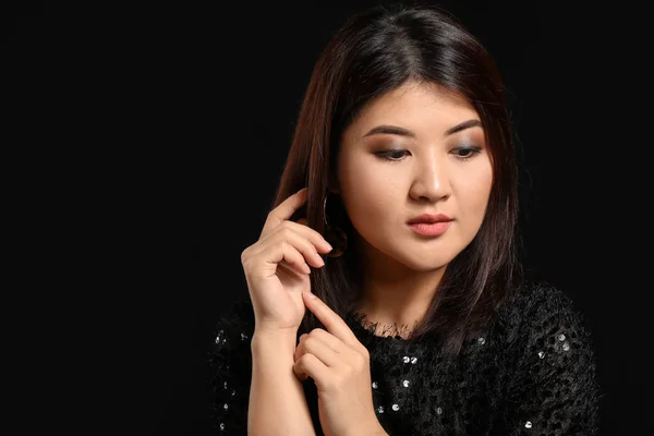 Portrait of young Asian woman on dark background — Stock Photo, Image