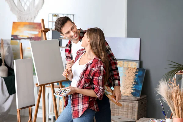 Couple of young artists working in studio — Stock Photo, Image