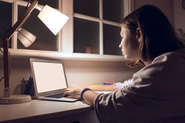 Teenage girl studying at home late in evening — Stock Photo, Image