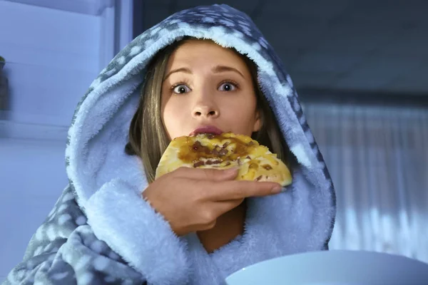 Teenage girl caught in the act of eating unhealthy food near refrigerator at night — Stock Photo, Image