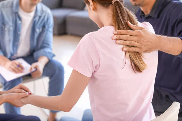 Young people calming sad woman during psychological support session — Stock Photo, Image