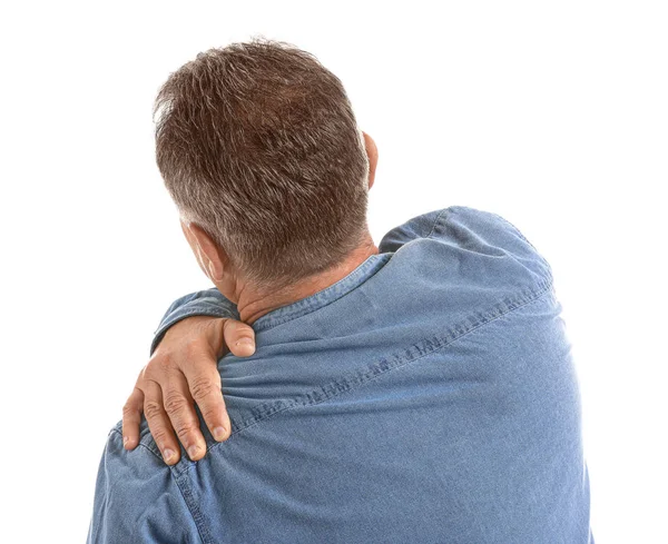 Mature man suffering from pain in shoulder on white background — Stock Photo, Image