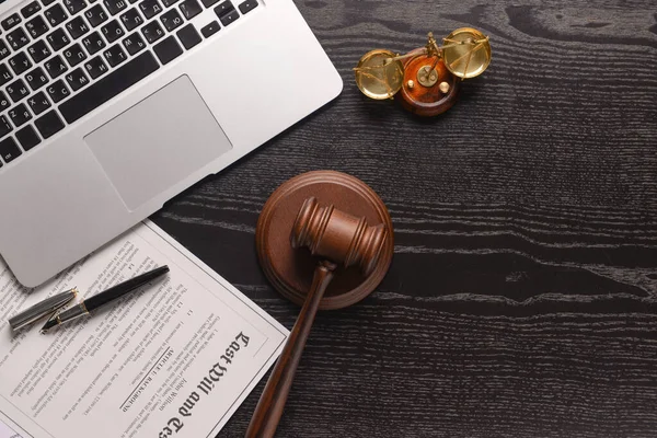 Scales of justice with judge's gavel, document and laptop on dark background — Stock Photo, Image