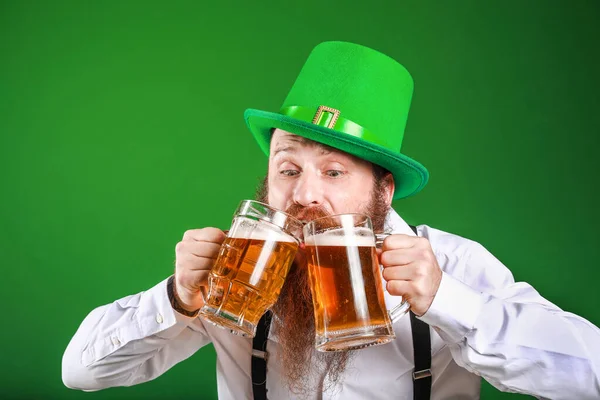 Bearded man with glasses of beer on color background. St. Patrick's Day celebration — Stock Photo, Image