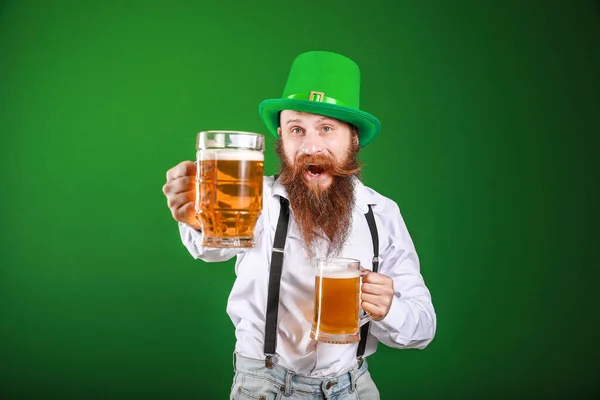 Bearded man with glasses of beer on color background. St. Patrick's Day celebration — 스톡 사진