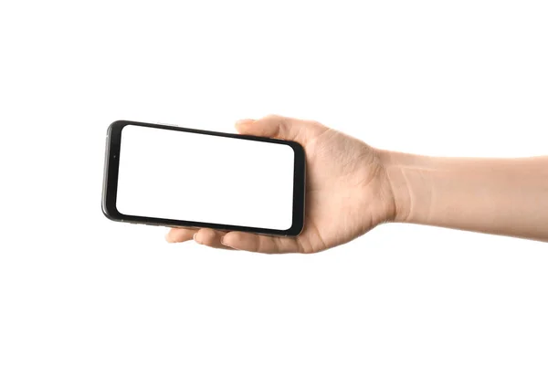 Женская рука с мобильным телефоном на белом фоне — стоковое фото