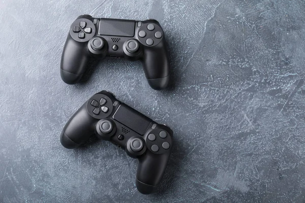 Modern game pads on grey background — 스톡 사진