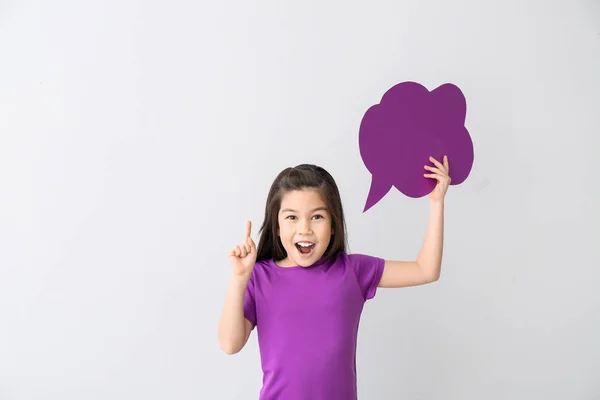 Cute little girl with blank speech bubble and raised index finger on white background — Stock Photo, Image