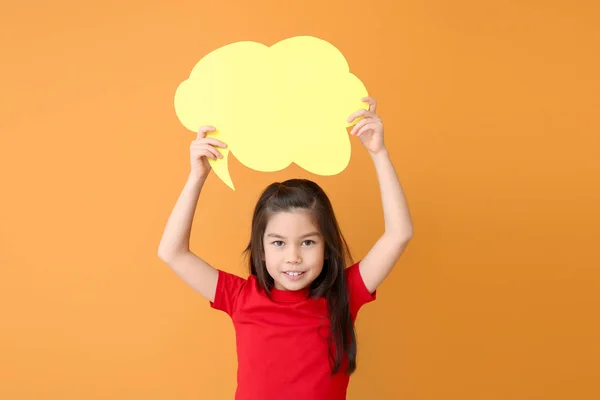 Cute little girl with blank speech bubble on color background — Stock Photo, Image