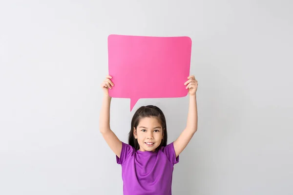Cute little girl with blank speech bubble on white background — Stock Photo, Image