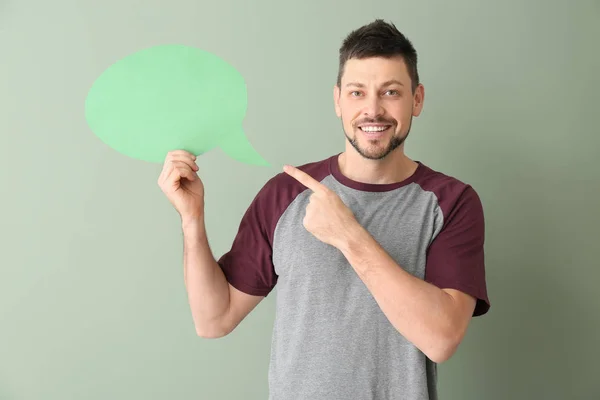 Man with blank speech bubble on color background — Stok Foto