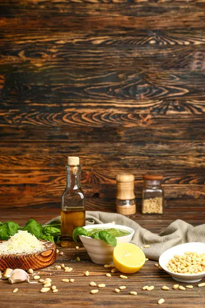 Pesto sauce with ingredients on wooden background — Stock Photo, Image