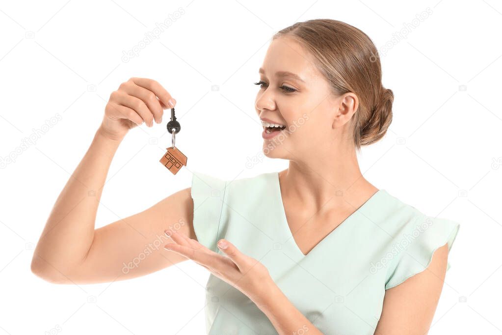 Female real estate agent with key on white background