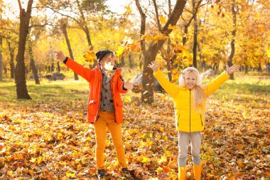 Sevimli küçük çocuk sonbahar parkta eğleniyor