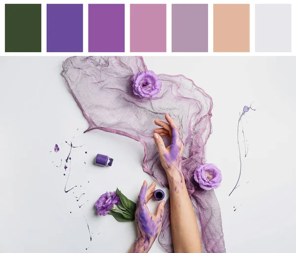 Artist's hands in paint, flowers and cloth on white background. Different color patterns — Stock Photo, Image