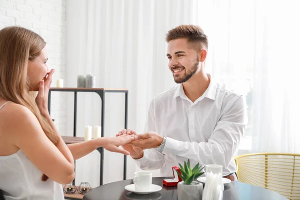 Jovem colocando anel no dedo de sua noiva após a proposta de casamento — Fotografia de Stock