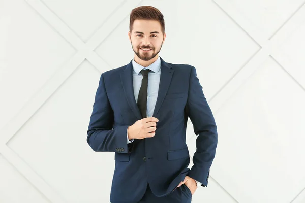 Portrait of handsome businessman on grey background — Stock Photo, Image