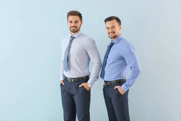 Portrait of young businessmen on color background — Stock Photo, Image