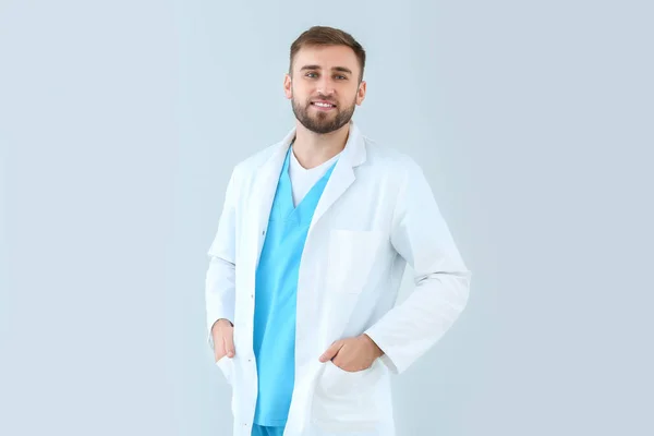 Portrait of male doctor on light background — Stock Photo, Image