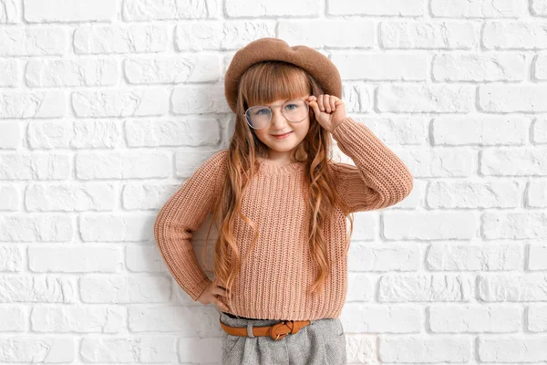 Cute fashionable girl on near white brick wall — 스톡 사진