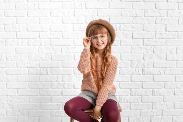 Cute fashionable girl near white brick wall — 스톡 사진