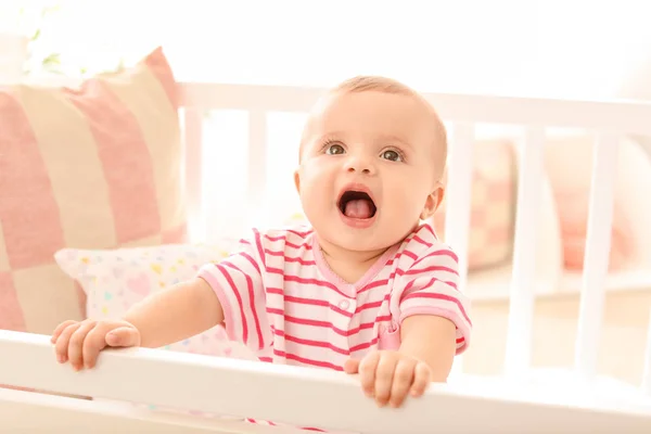 Portrait of cute little baby in crib at home — Stock Photo, Image