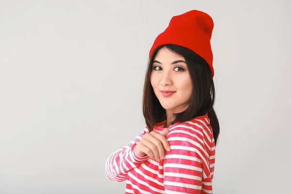 Portrait of beautiful young Asian woman on light background — Stock Photo, Image