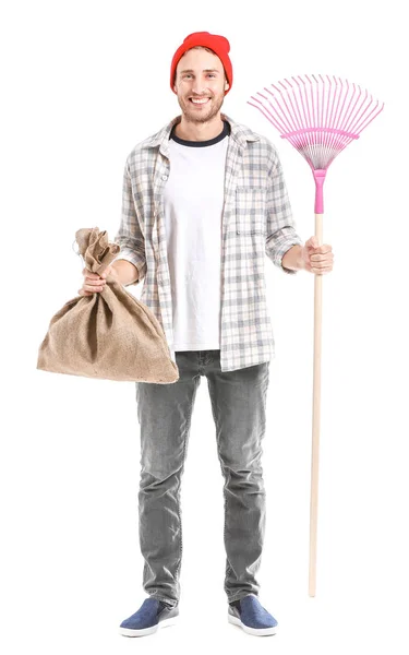 Man with rake for autumn leaves clean-up on white background — Stock Photo, Image