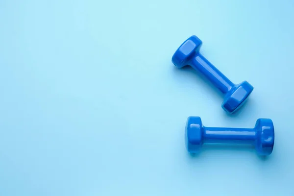 New dumbbells on color background — Stock Photo, Image