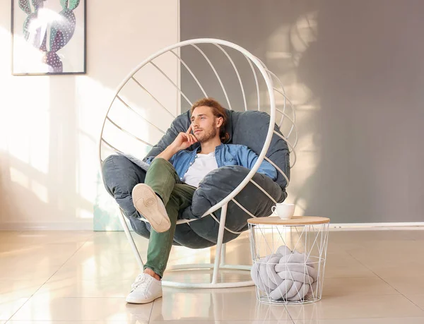 Handsome man with newspaper at home — Stock Photo, Image