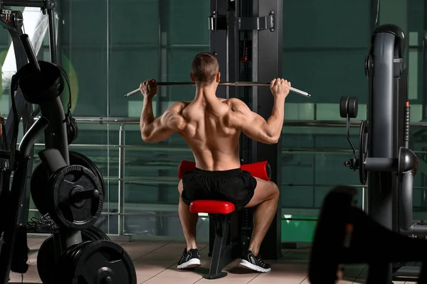 Sporty muscular man training in gym — 스톡 사진