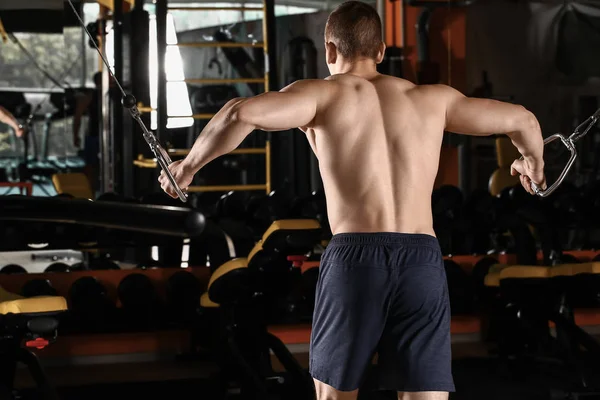 Sporty muscular man training in gym — Stock Photo, Image