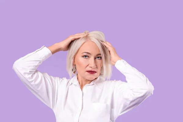 Fashionable mature woman on color background — Stock Photo, Image