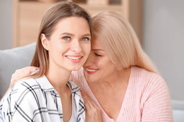 Mature woman and her adult daughter spending time together at home — 스톡 사진