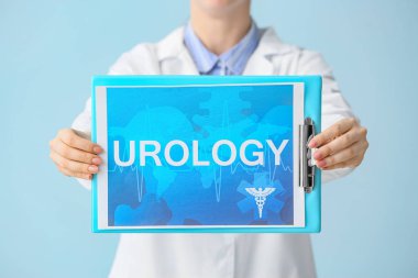 Işık arkaplanı üzerine metin ürolojisi içeren kağıt tutan doktor