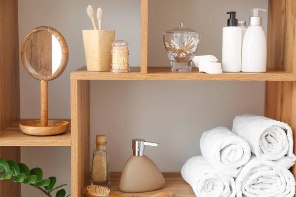 Body care cosmetics with accessories on shelves in bathroom — Stock Photo, Image