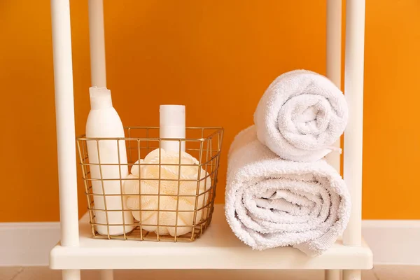 Body care cosmetics with accessories on shelf in bathroom — Stock Photo, Image