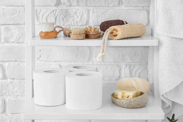 Body care cosmetics with accessories on shelves in bathroom — Stock Photo, Image