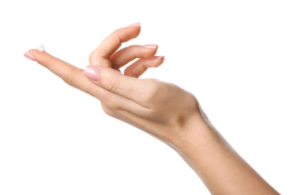 Hand of young woman with cosmetic cream on white background — 스톡 사진